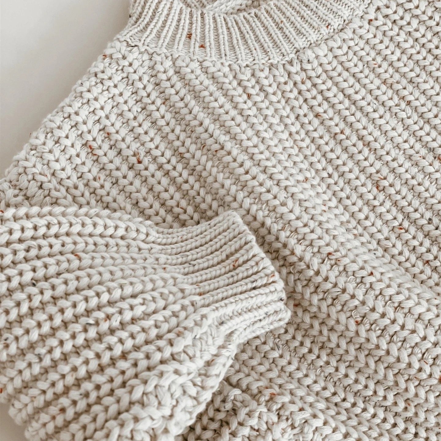 Beige knitted baby sweater